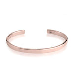 Rose gold bangle on a white background