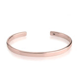 Rose gold bangle on a white background