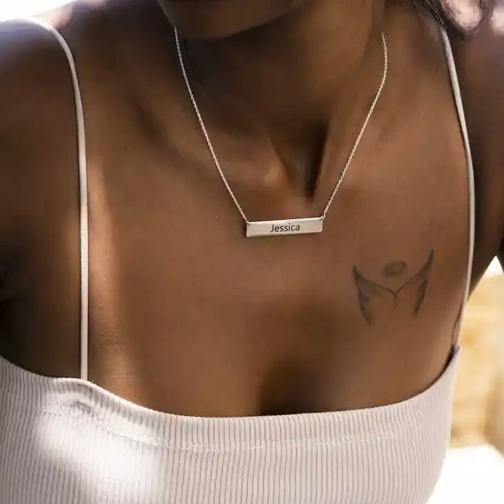 women wearing a necklace with a nameplate