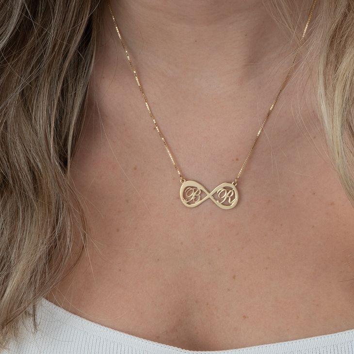 Gold infinity necklace with two interlocked letters