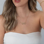 Infinity name necklace with heart worn on neck for size reference